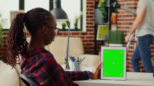Woman Holds Tablet with Green Screen in Home