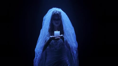 Woman in Veil Holding Candle in Dark