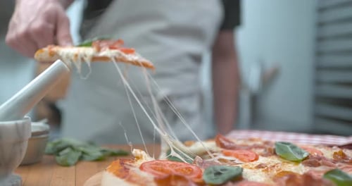 Freshly Baked Pizzeria Pizza Being Sliced with Melty Cheesy Closeup Ultra Slow
