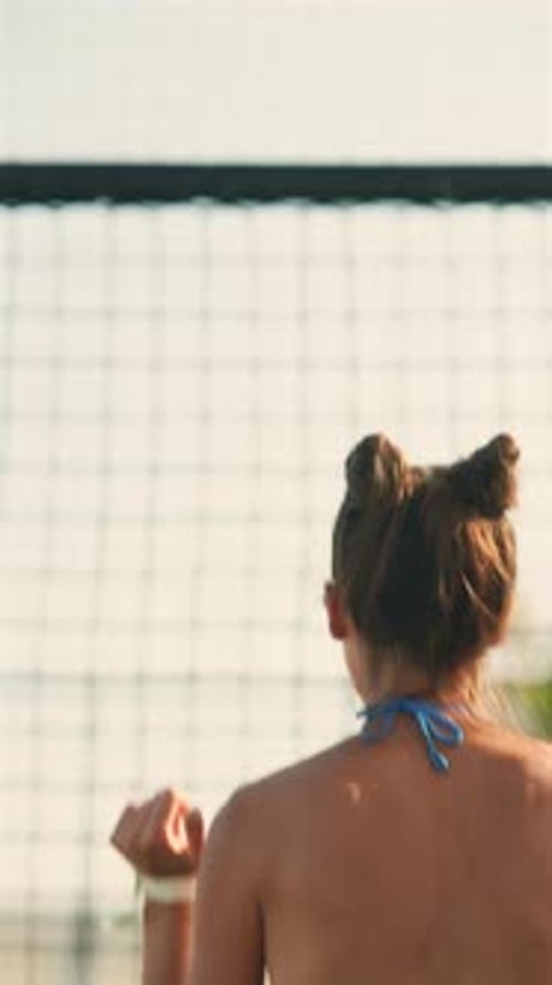A Moment of Joy Unfolds As a Stunning Girl in Glasses and a Bikini Jumps on the Beach