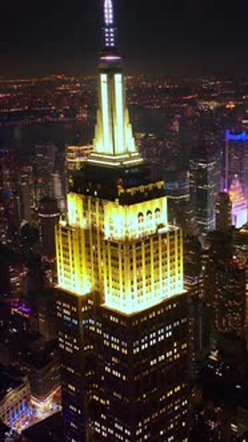 Fascinating Empire State building with lighted top at night. Striking scenery of New York skyscraper