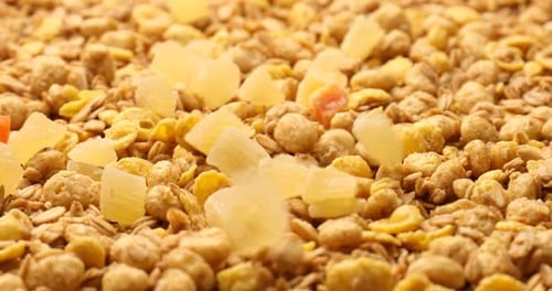 Granola with Dried Fruits Being Poured