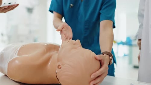 Healthcare Workers Train Palpating a Mannequin's Neck