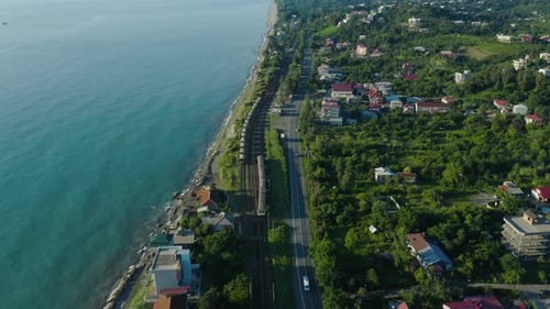 Trains On The Coastal Railway Near Chakvi Railway Station In Georgia At Daytime. aerial drone