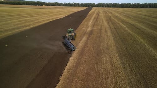 Tractors plowing the field in Ukraine