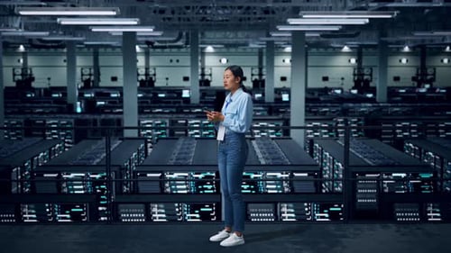 Side View Of Full Body Asian Business Woman Using Mobile Phone An Looking Around In Data Center