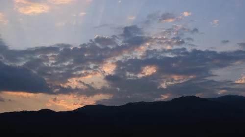 Sun Rays and Clouds Time-Lapse over Mountains