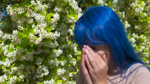 Teen with Blue Hair Sneezes Outside in Springtime