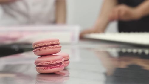 Delicious Pink Raspberry Macaroons on the Table at Commercial Kitchen