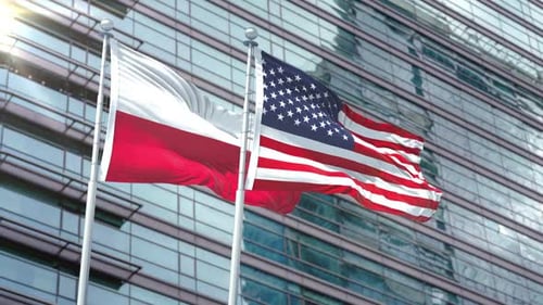 Realistic Flags of Poland and USA Waving in Front of Modern Building