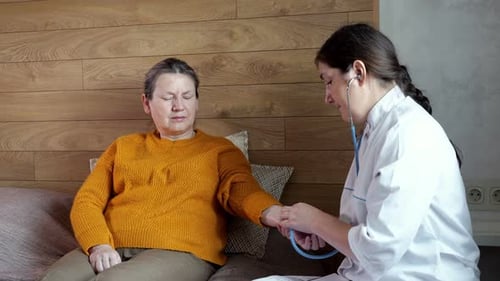 Doctor Checks Patient at Home Using Stethoscope