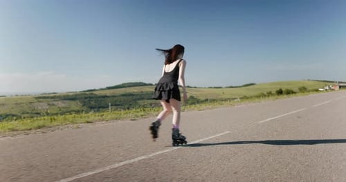 Sporty Woman in Black Dress Riding on Roller Skates Outdoor