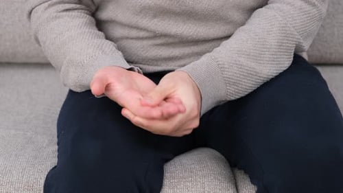 Person Wringing Fingers in Close Up Studio Shot