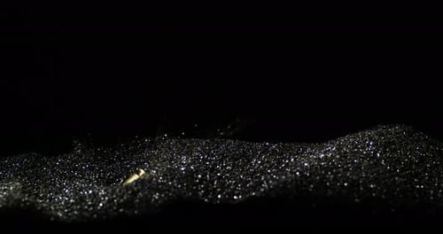 919mm Parabellum Cartridges Dropping Into Heap Of Bullet Grains. closeup, slow motion shot