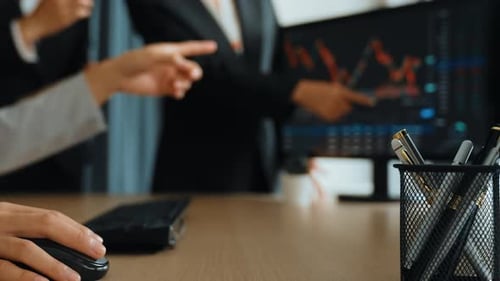 Business Professionals Analyzing Financial Charts in an Office