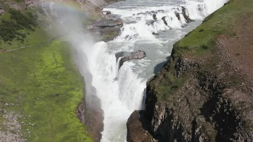 Sunny day at Gullfoss waterfall in Iceland, water mist creating rainbow