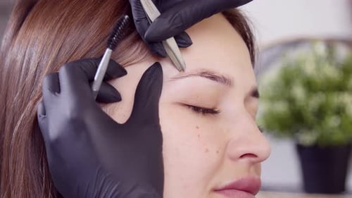Woman Receives Eyebrow Shaping Treatment Close Up