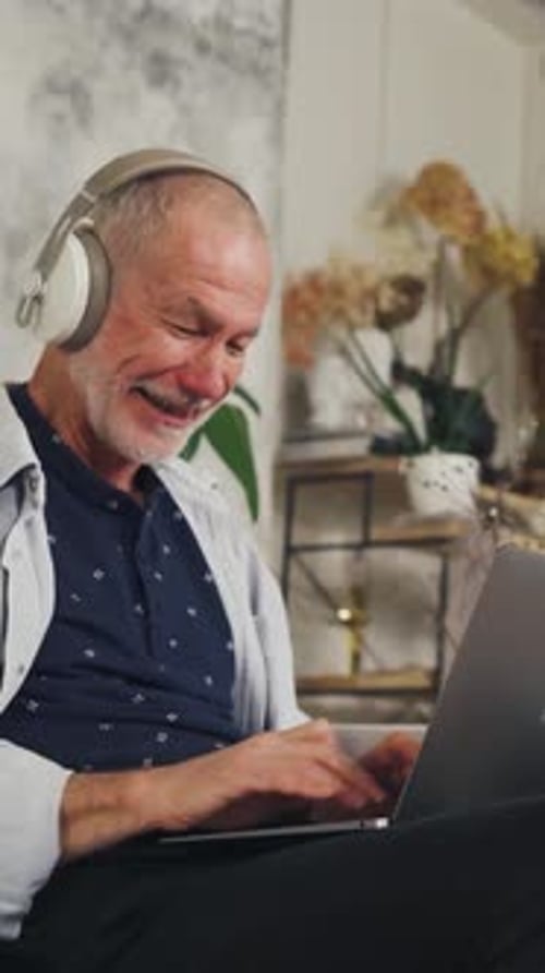 Senior Man Video Call on Laptop at Home