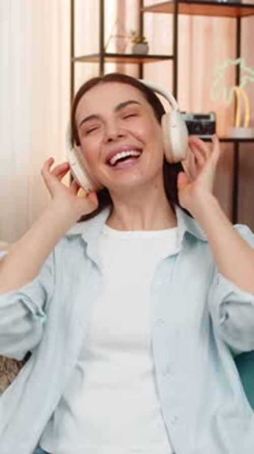 Woman Enjoys Music with Headphones at Home