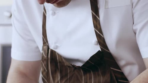 Chef Plates Sliced Meat in Restaurant Kitchen