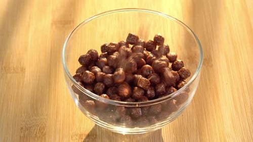 Chocolate Cereal Balls Filling a Glass Bowl