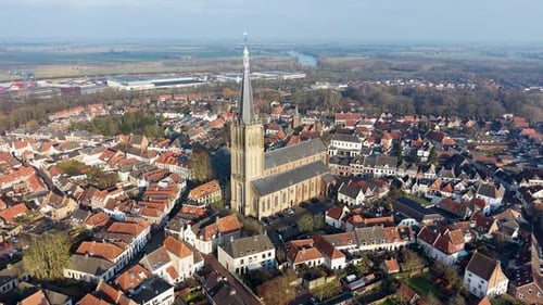 An impressive aerial view of a historic European town center, dominated by a grand cathedral