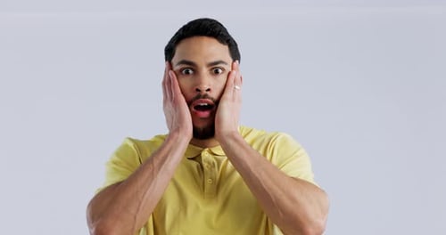 Face, surprise and man with wow, mockup space and announcement on a white studio background