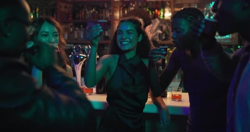 Excited people, night club and cheers with drink for party, celebration or toast together
