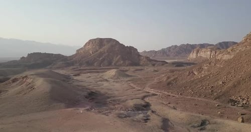 Flying over rocky desert mountains