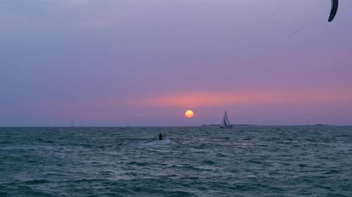 Kite surfers and sail boats enjoy a day of leisure at Dubais famous kite beach