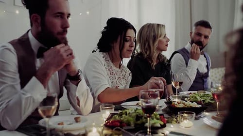Friends Gathered Around Table Eating Food and Talking
