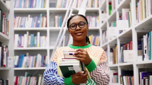 Portrait of African American Female Student with Books in the Library