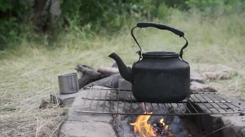 Old Kettle Standing on a Tourist Campfire in Nature