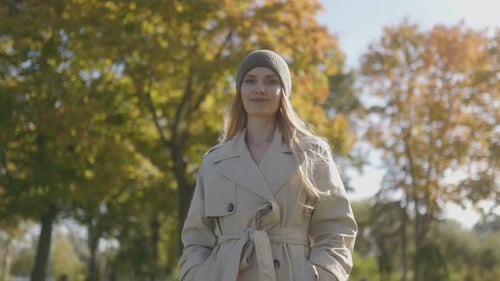 Woman in Fall Fashion Enjoying a Sunny Outdoor Scene
