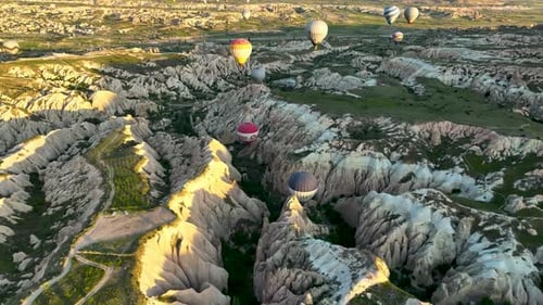 Hot Air Balloons Fly Over the Mountainous Landscape of Cappadocia Turkey