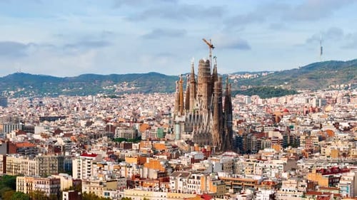 Aerial drone view of Sagrada Familia in city downtown. Famous residential districts around, greenery