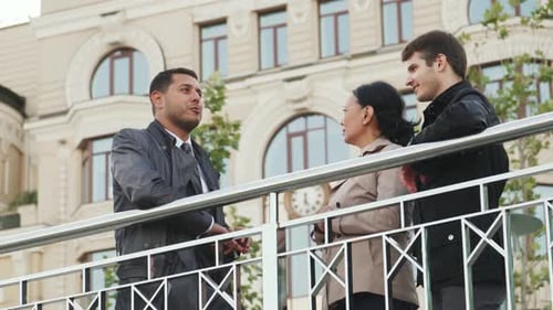 Engaging Conversation Among Three Professionals on a City Street