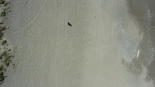 Person walking alone on a beach