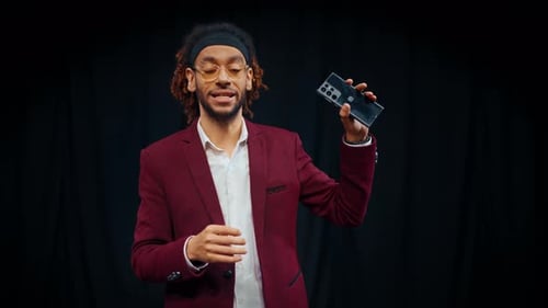 Presentation of Innovative Smartphone Portrait of Black Man with Gadget Professional Sales and