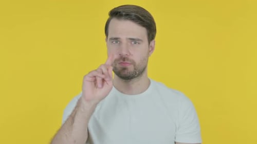 Man Shakes Head and Puts Finger Up