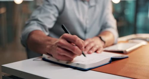 Hands, man and writing notes in office for article research, story planning and publishing schedule