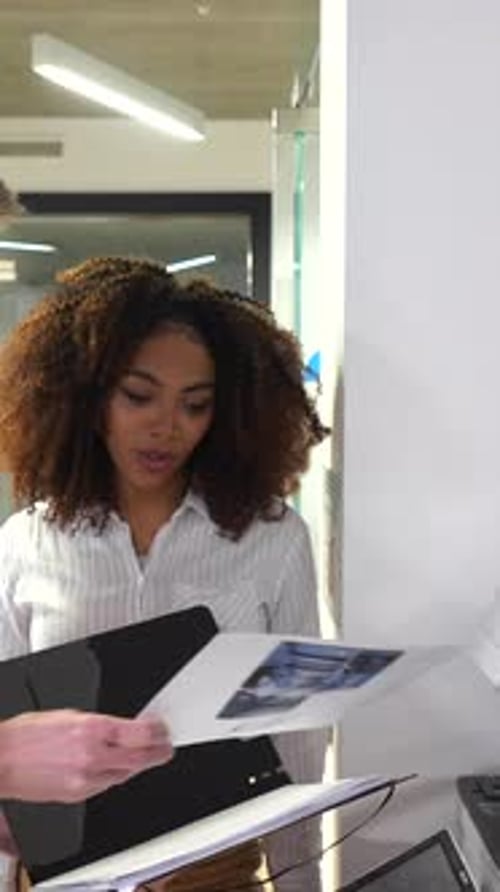 Business Colleagues Reviewing Documents in Coworking Space