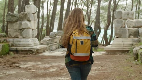 Journey through the streets of the ruined ancient city on the seaside. The camera follows a woman.