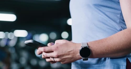 Hands, phone and person in gym for fitness, training information or check stats