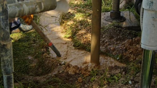 Drilling a water well in the ground to access fresh water supply