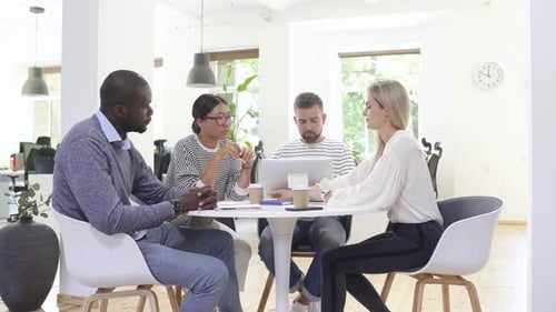 Diverse Team Meeting in Modern Office