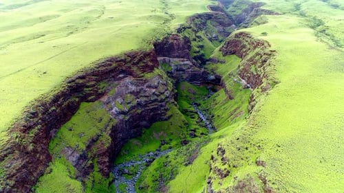 Flying over lush green canyon on east side of Maui, Hawaii.