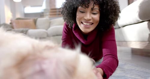 Woman Pets a Fluffy Dog at Home
