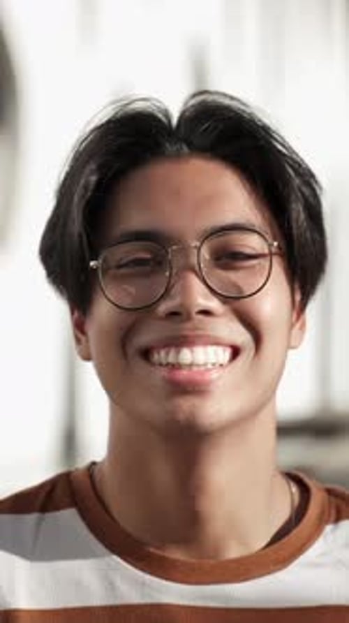 Smiling Young Adult with Stylish Glasses