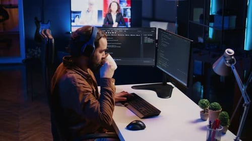 Young Adult Working on Computer at Desk